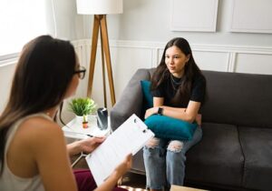 teen girl with therapist during adhd therapy in massachusetts