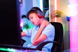 An individual showing symptoms that require teen video gaming addiction treatment