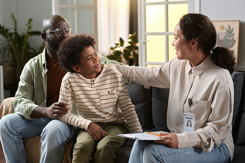 Family meeting with culturally sensitive therapist to discuss teen mental health care and family values.